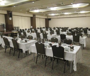Large banquet room with set tables at Kikuchi Kanko Hotel Kumamoto Kyūshū