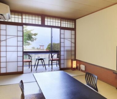 Traditional tatami room with low table and shoji doors opening to balcony seating, Kikunoya, Hiroshima, Chūgoku