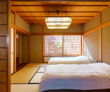 Tatami room with two low beds and shoji screen at Kinjohro in Ishikawa, Chūbu, Japan