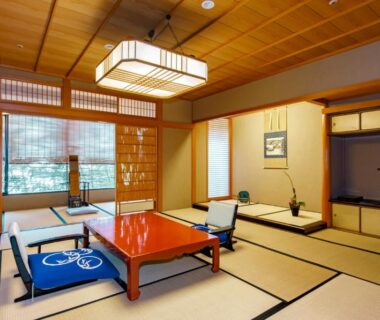 Tatami room with low lacquered table, zabuton cushions and tokonoma at Kinjohro, Chūbu Ishikawa Japan