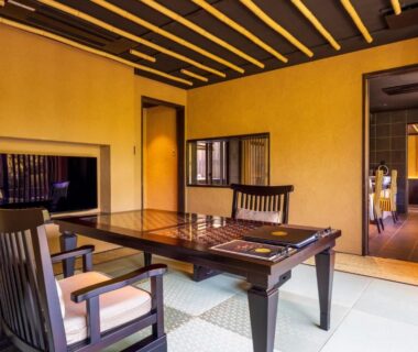 Interior tatami room with low wooden table and chairs at Kinnotake Sengokuhara in Kanagawa