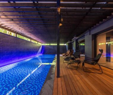 Indoor pool with wooden deck and lounge chairs at Kinnotake Tonosawa in Kanagawa, Kantō