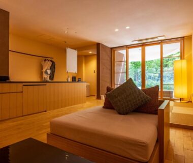 Spacious wooden interior with low seating, tatami platform and garden view at Kinnotake Tonosawa Kanagawa
