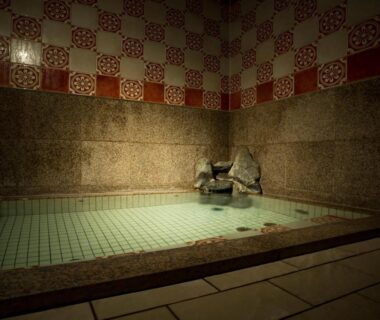 Indoor tiled onsen bath with stone water spout at Kinosaki Onsen Hanakouji Saigetsu, Hyōgo, Kansai