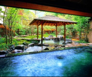 Outdoor onsen bath with wooden gazebo and garden at Nishimuraya Hotel Shogetsutei Hyōgo