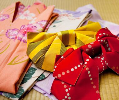 Folded yukata and patterned obi on tatami at Kinosaki Onsen Nishimuraya Hotel Shogetsutei, Hyōgo Japan