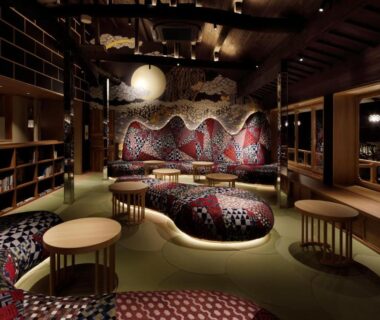 Patterned lounge with low tables, mural and bookshelves at Kinosaki onsen Tokitotoki, Hyōgo, Japan