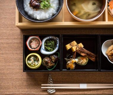 Assorted small Japanese dishes with soup and chopsticks at Kinosaki onsen Tokitotoki, Hyōgo