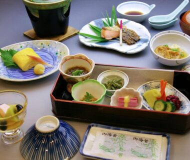 Assorted small dishes and sashimi in lacquered tray at Kinparo Kyoto ryokan