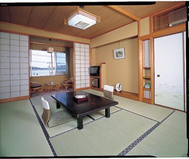 Traditional tatami room with low table, floor cushions, shoji screens and sliding fusuma at Kinpokan in Mie