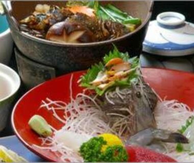 Fresh sashimi on red lacquer tray with simmering pot and side bowls at Kinpokan, Mie, Kansai