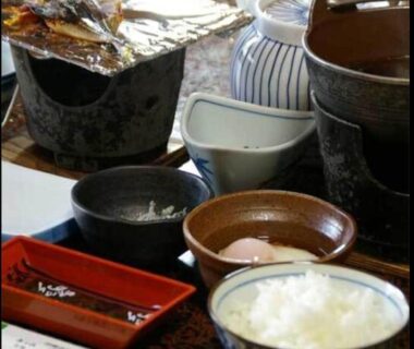 Assorted ceramic bowls, rice and small dishes arranged on a lacquer tray at Kinpokan, Mie