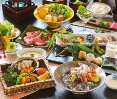 Assorted traditional dishes and sashimi on a table at Kinsuikan in Hiroshima