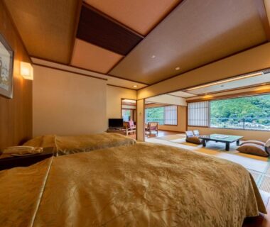 Tatami room with twin beds, shoji screens and garden view at Kinugawa Hotel Mikazuki, Tochigi