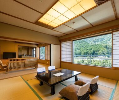 Spacious tatami room with low table, shoji screens and mountain view at Kinugawa Hotel Mikazuki, Tochigi