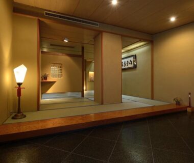 Genkan entryway leading to tatami room with shoji screens and soft lantern lighting at Kinugawa Onsen Hana no Yado Matsuya