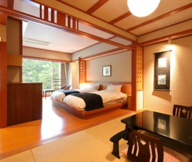 Tatami room with twin beds, low table and garden view at Kinugawa Onsen Hana no Yado Matsuya, Tochigi