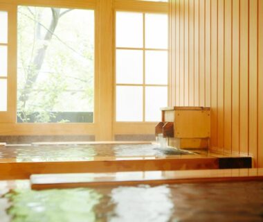 Indoor wooden onsen baths with shoji windows and garden view at Kinugawa Onsen Hotel Tochigi Kantō