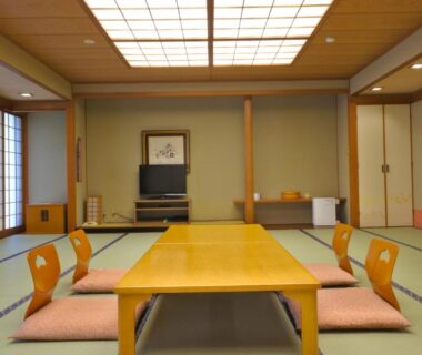 Traditional tatami room with low table and floor chairs at Kinugawa Onsen Hotel, Tochigi, Kanto, Japan