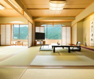 Traditional tatami room with low table, shoji screens and mountain view at Kinugawa Onsen Sanraku, Tochigi