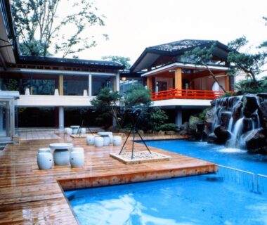 Wooden deck and outdoor pool with waterfall at Kinugawa Park Hotels, Tochigi