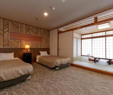 Guest room with two beds, tatami seating area, shoji screens and low table