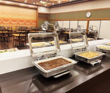 Chafing dishes on buffet counter with dining tables and sliding partition panels at Kinugawa Royal Hotel