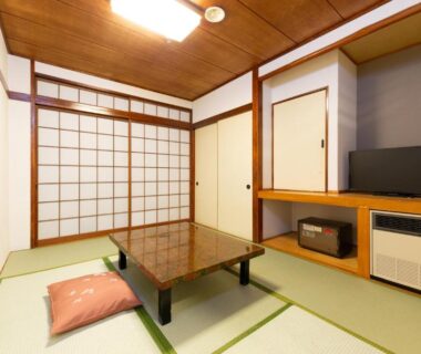 Tatami room with low table and shoji screens at Kinugawa Royal Hotel in Tochigi, Kantō, Japan