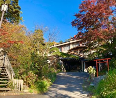 Approach to Kirishimaya Ryokan with stone path, wooden stairs and autumn foliage in Gunma