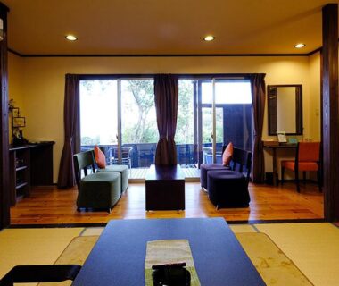 Tatami room with low table and seating area at Kisara ryokan in Mie, Kansai