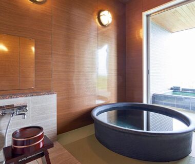Round soaking tub and shower area in Kisara Bettei TOKI ryokan, Mie, Kansai