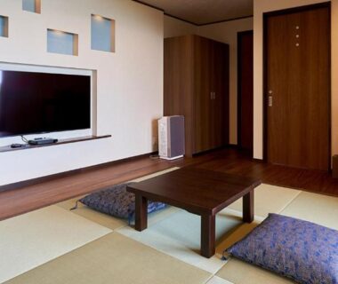 Tatami mats, low table and cushions with wall TV and cabinet in Kisara Bettei TOKI room, Mie, Kansai Japan
