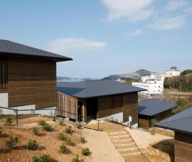 Wooden ryokan buildings on hillside pathway with sea view in Mie, Kansai region, Japan