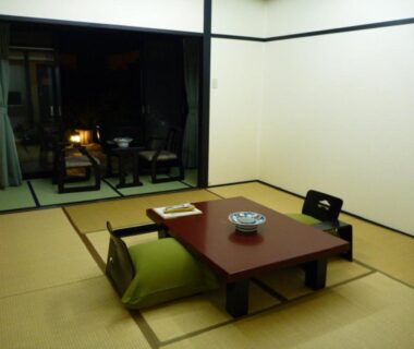 Tatami room with low table, floor chairs and sliding glass doors at Kisoya, Gifu, Chūbu, Japan