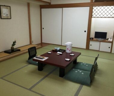 Traditional tatami room with low table, zabuton chairs and tokonoma at Kisoya in Chūbu, Gifu, Japan
