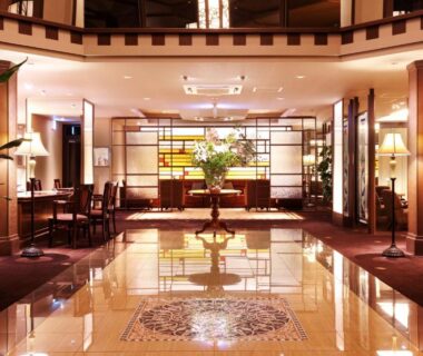 Polished tile lobby with seating, reception desk, and central floral arrangement at Kissho Caren, Shizuoka, Chūbu Japan