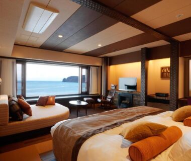 Tatami-style room with beds, seating area and ocean view at Kitakobushi Shiretoko Hotel & Resort, Hokkaidō