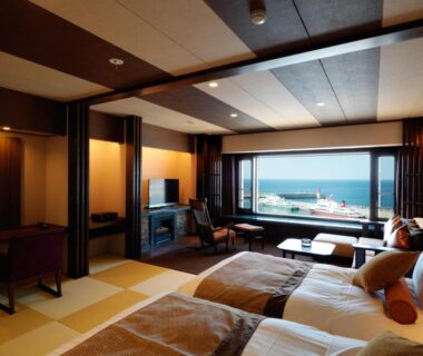 Twin beds, tatami flooring and seating with sea view at Kitakobushi Shiretoko Hotel & Resort, Hokkaidō, Japan
