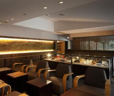 Interior lounge with wooden chairs and display counter at Kitanokaze Saryo in Kanagawa