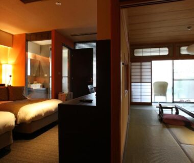 Tatami room with shoji screens, low table, twin beds and visible wooden bath in Kitanokaze Saryo, Kanagawa
