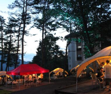 Illuminated outdoor tents and tables at Kitashiga Holiday Inn in Chūbu, Nagano, Japan