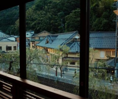 Interior window overlooking traditional Kinosaki rooftops at Kobayashiya in Hyōgo, Japan