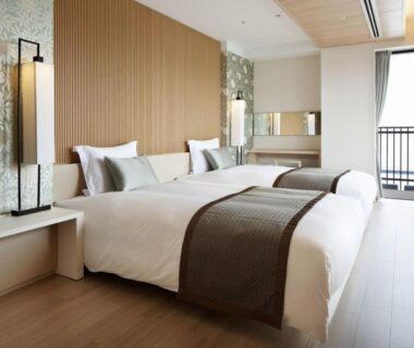 Twin beds, wooden floor, balcony view at Kobe Minato Onsen Ren, Hyōgo, Kansai, Japan