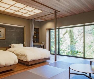 Tatami room with two low beds, garden-facing window and low table at Kocho, Ishikawa, Chūbu
