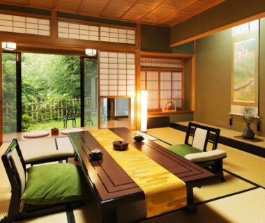 Tatami room with low dining table, shoji screens and garden view at Kocho, Ishikawa, Japan