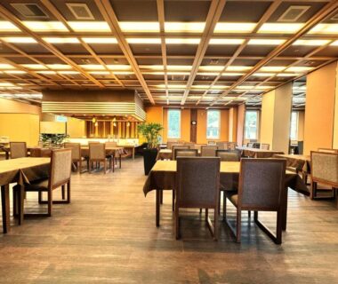Wooden floor dining hall with grid ceiling lighting at Kochoran, Mie, Kansai, Japan