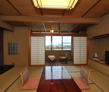Tatami room with low table, shoji screens and seating cushions at Kohan-no-Yado Morimoto in Ishikawa