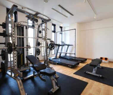 Small fitness room with multi-gym machine, treadmill and free weights at Kojohama Onsen Hotel in Hokkaidō
