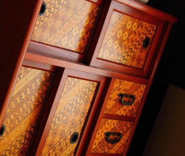 Decorative wooden tansu chest with patterned panels in a traditional ryokan interior at Kokoronodoka Shizuoka