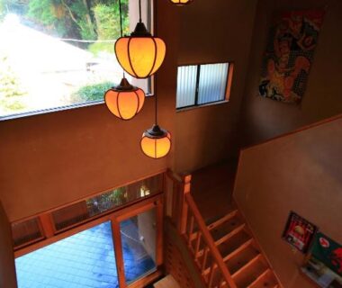Hanging pendant lanterns over wooden stairwell and entrance at Kokoronodoka, Shizuoka, Chūbu Japan
